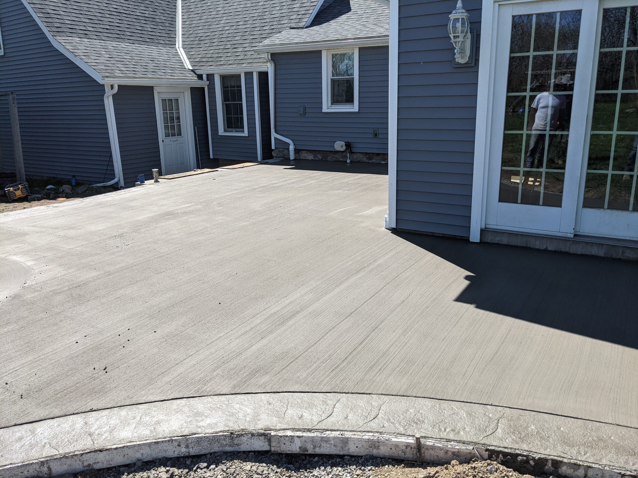 Broomed concrete patio with stamped concrete border