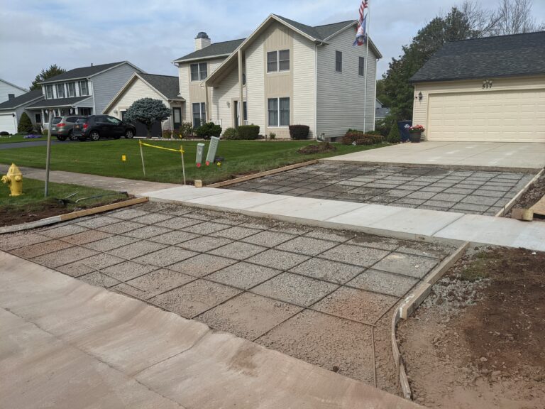 Residential concrete driveway being poured with rebar grid visible