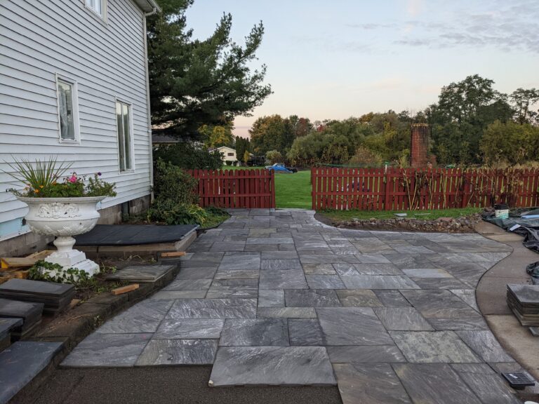 Natural stone paver patio and curved walkway with flagstone pattern
