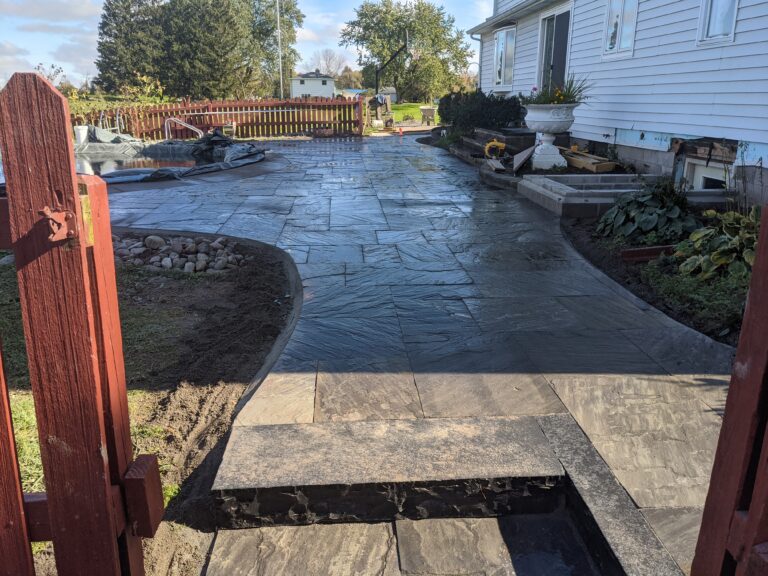 Natural flagstone patio with stone slab steps at residential home