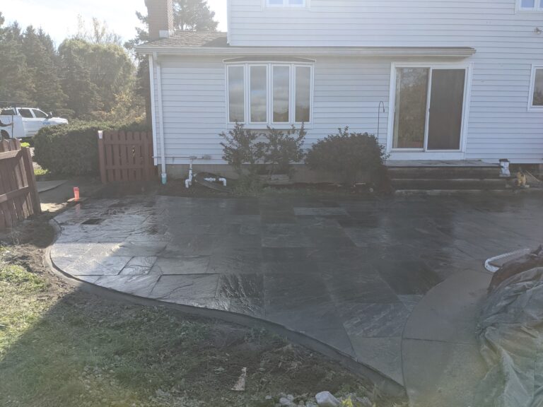 Natural flagstone patio with curved concrete border edging