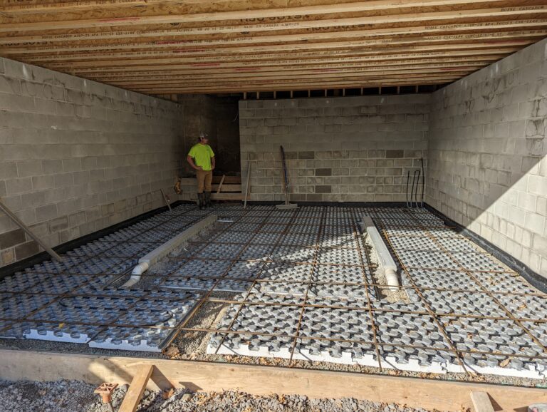 Radiant heat tubing and rebar grid in basement floor ready for concrete pour