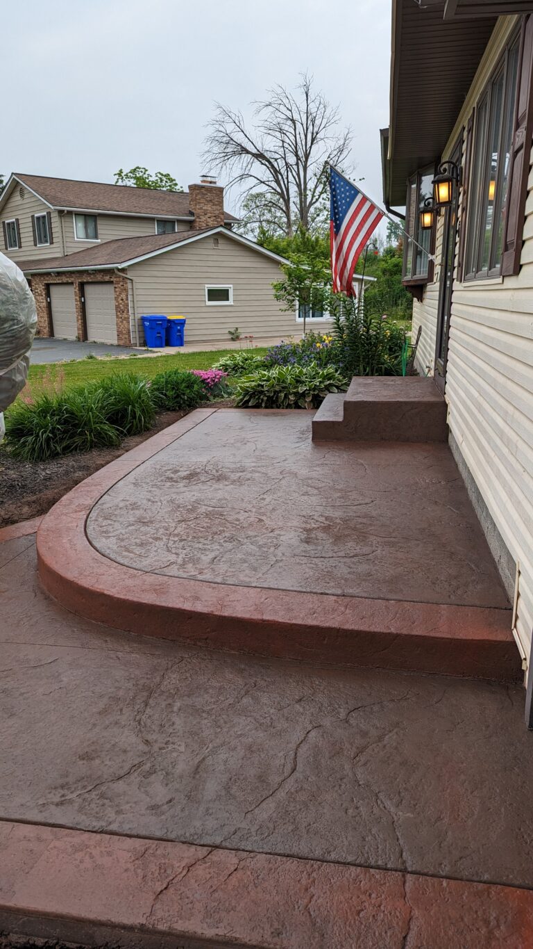 Stamped concrete front porch, steps, and walkway with colored border