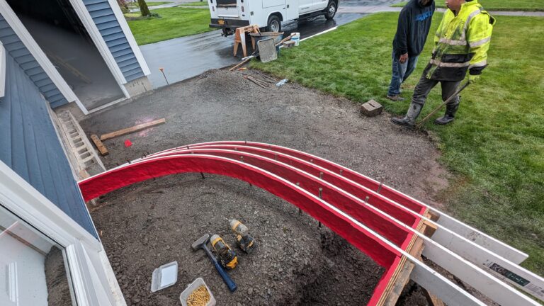 Overhead view of curved concrete forms for front entry steps