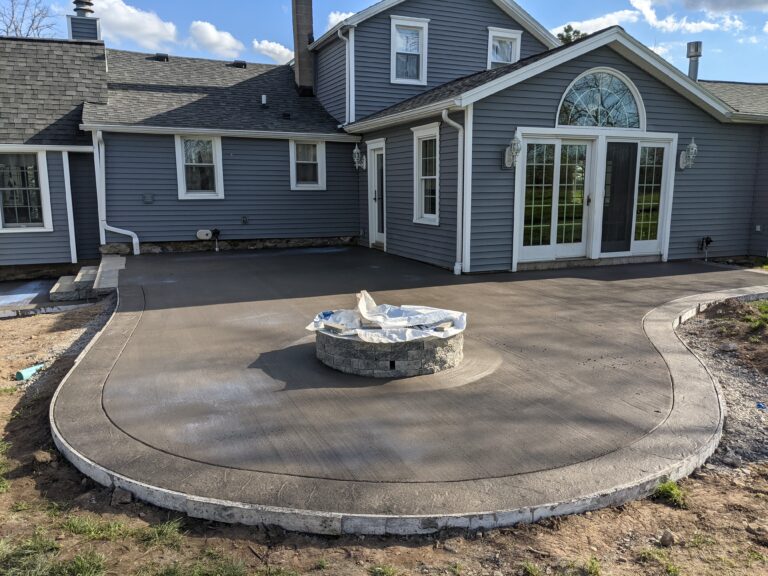 Broomed patio with stamped concrete border and fire pit