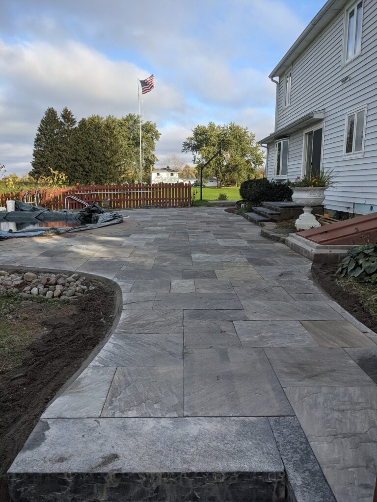 Natural stone patio with stamped concrete border