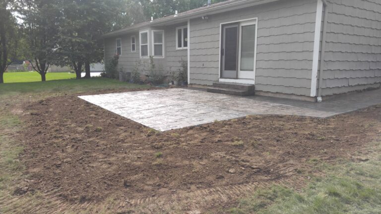 Stamped concrete patio behind house