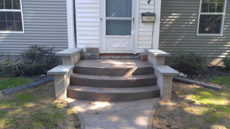 Concrete front steps with stone veneer columns