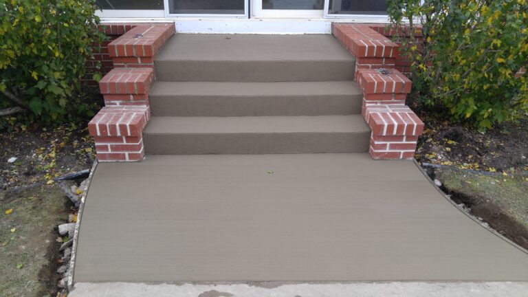Concrete front steps with brick pillars