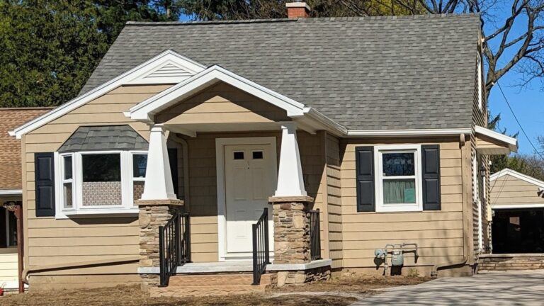 Stone veneer porch columns with natural stone caps in Rochester, NY