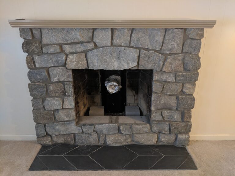 Natural stone fireplace surround with slate hearth