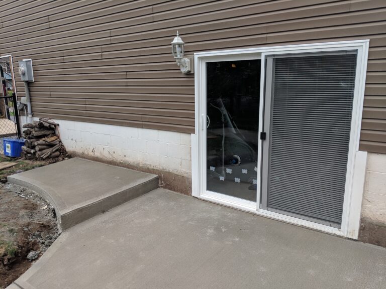 Concrete patio with sliding door entry
