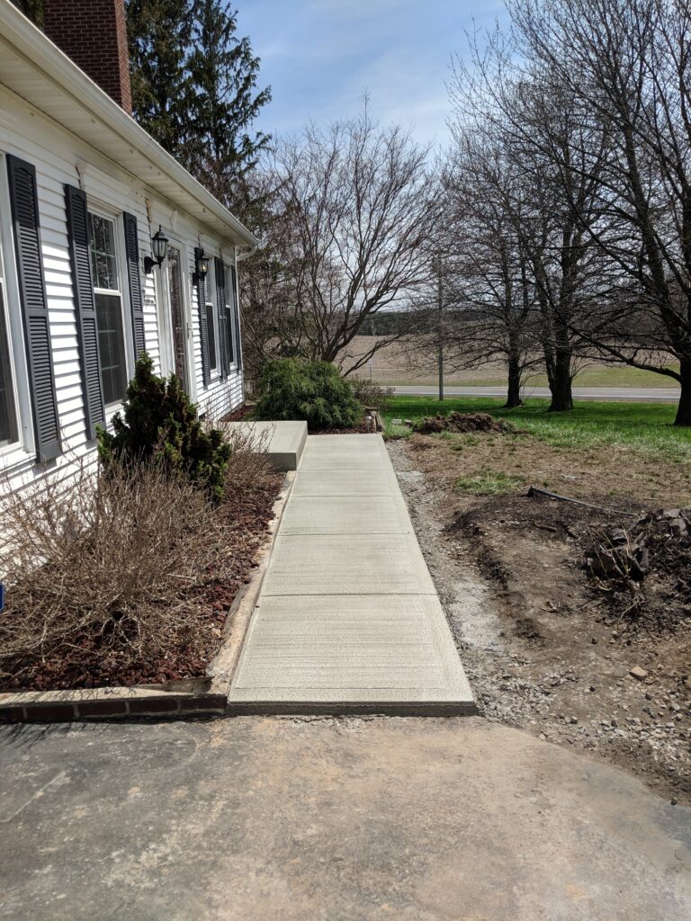 Concrete front walkway along house