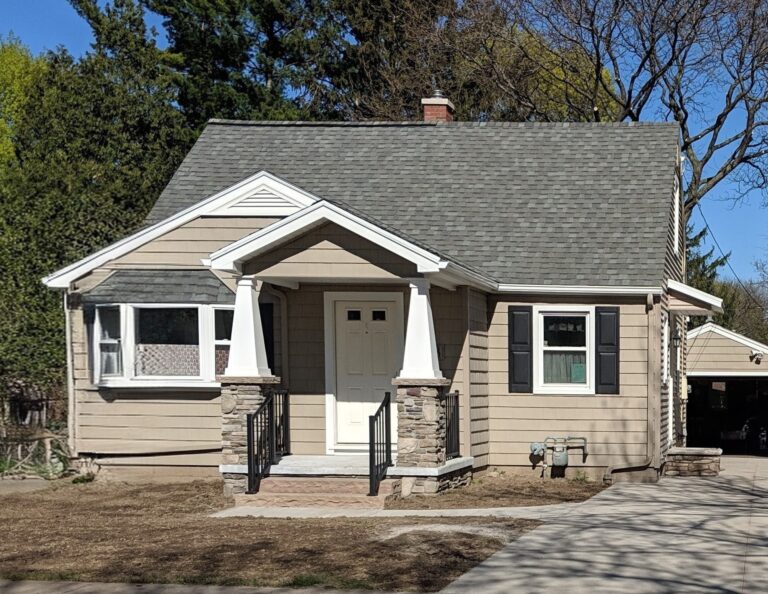 Home exterior with stone veneer porch columns