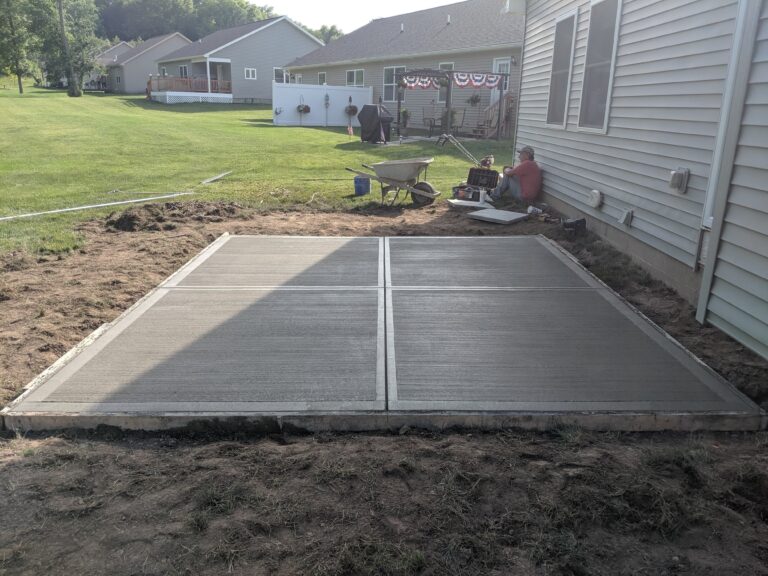 Broomed concrete backyard patio with control joints
