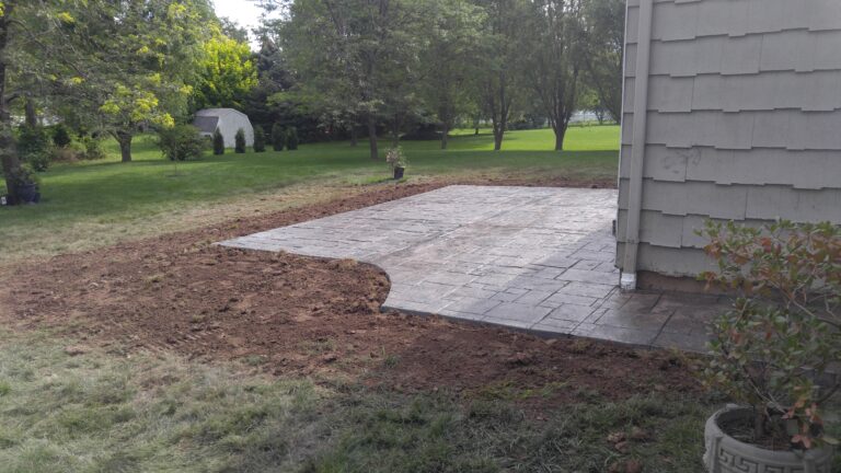 Newly installed ashlar pattern stamped concrete patio next to residential home – Monroe County NY