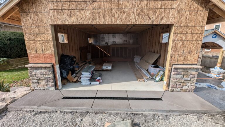 New concrete garage apron with trench drain at threshold on a newly built garage – Rochester NY
