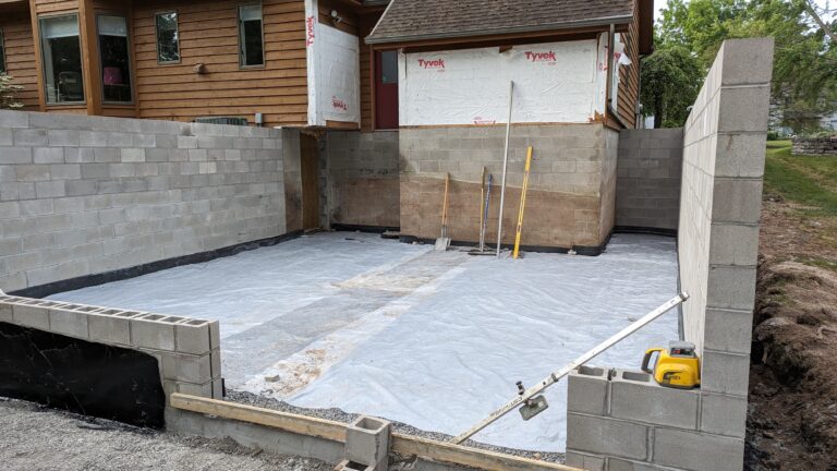CMU block foundation walls with vapor barrier floor prep staged for concrete slab pour – Rochester NY