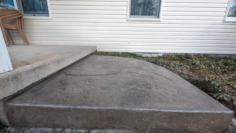 New stamped concrete step and landing installed beside home foundation – Rochester NY
