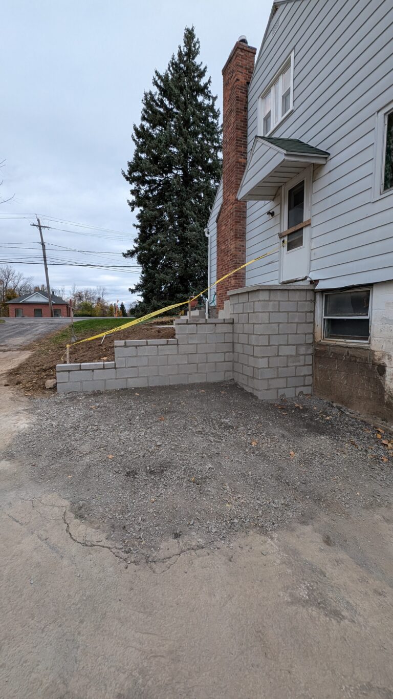 New CMU concrete block foundation wall added to side of existing residential home during renovation – Rochester NY