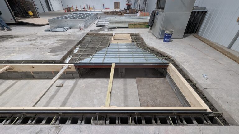 Rebar grid and corrugated metal deck formwork laid over commercial in-ground concrete pit – Rochester NY