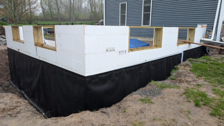 New home poured concrete foundation walls with foam insulation and dimple mat waterproofing membrane – Rochester NY