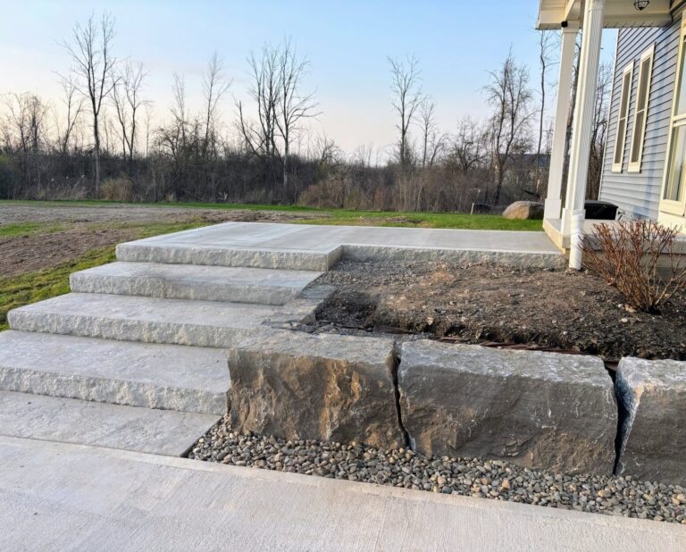 Side-angle view of a fresh concrete pool deck slab in wood forms at a new construction site in Fairport NY