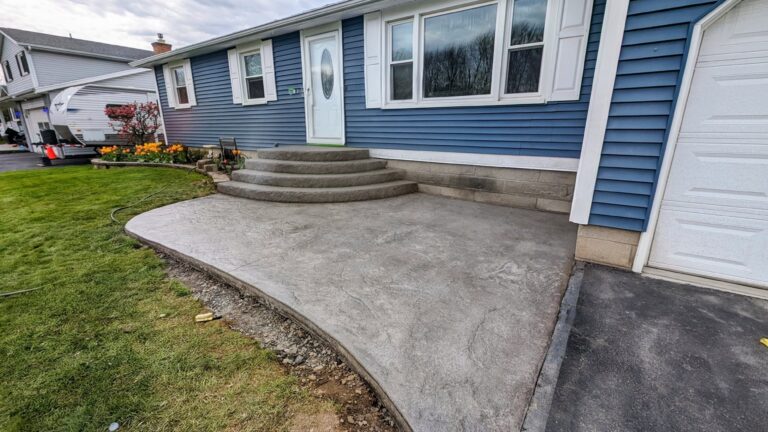 Completed curved stamped concrete front stoop with steps at blue ranch home – Rochester NY