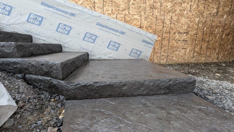 Close-up of stamped concrete steps with bold stone-face risers at construction site – Rochester NY
