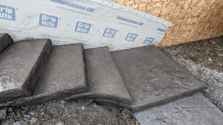 Close-up of freshly formed stamped concrete steps with stone-face risers at new construction – Rochester NY